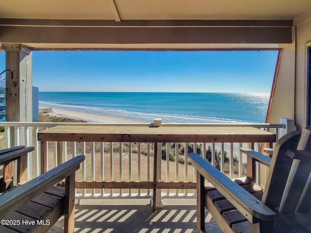 deck featuring a water view and a view of the beach