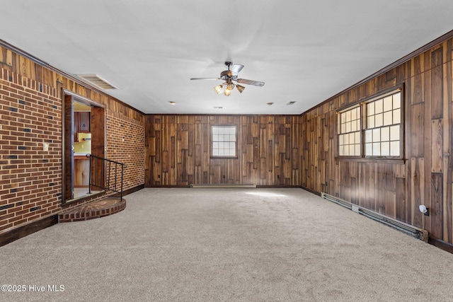 unfurnished room featuring a baseboard heating unit, carpet, and visible vents