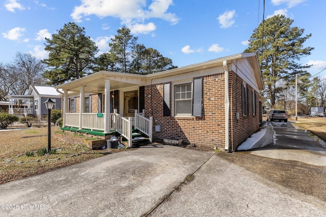 view of front of property featuring a porch and brick siding