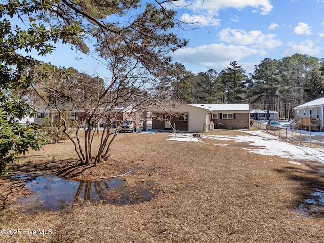 view of yard with driveway and fence