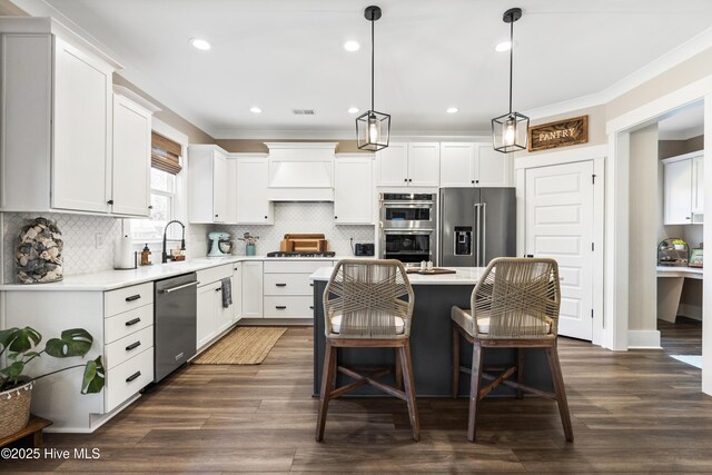 office space with crown molding, built in study area, and dark wood finished floors