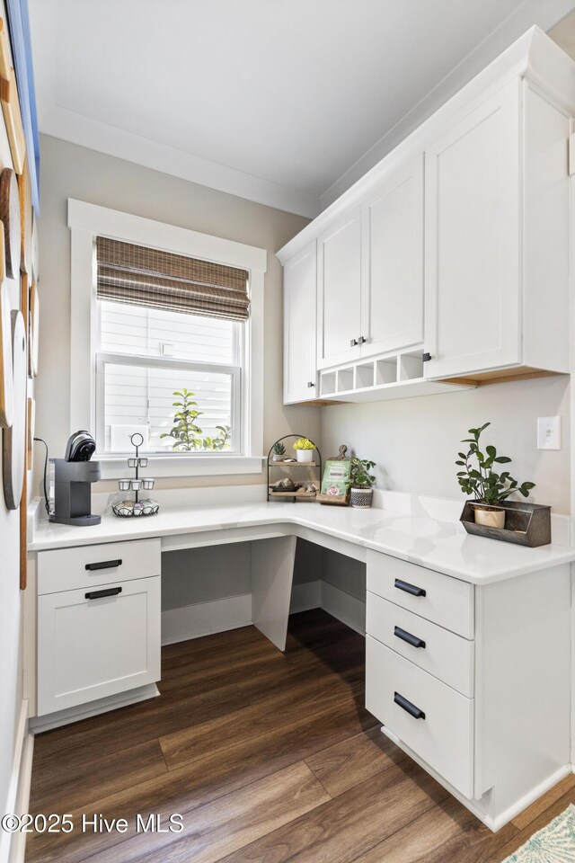 kitchen with stainless steel appliances, light countertops, a kitchen island, and white cabinetry