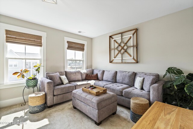 living area with carpet, visible vents, baseboards, and recessed lighting