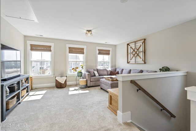 carpeted bedroom with visible vents, baseboards, and crown molding