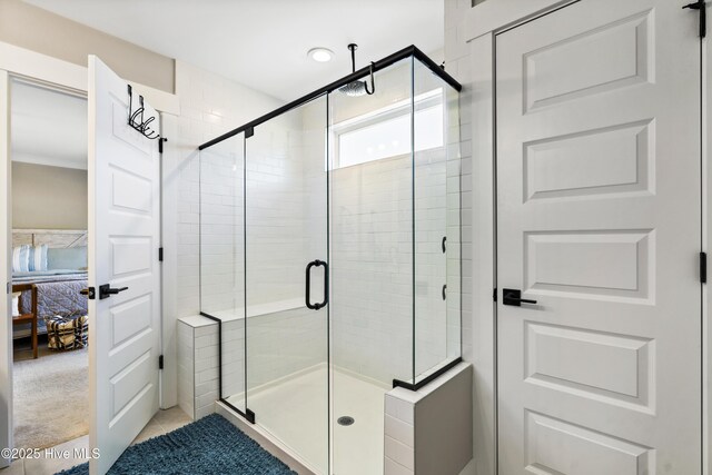 full bathroom with tile patterned flooring, visible vents, a sink, and a shower stall