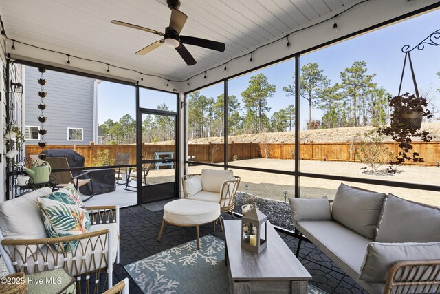 back of house featuring a sunroom, roof with shingles, fence, and ceiling fan