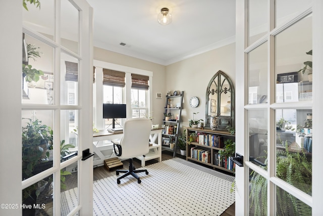 office area with wood finished floors, visible vents, and crown molding