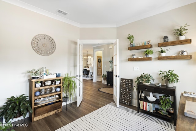 interior space with baseboards, dark wood-style flooring, visible vents, and crown molding