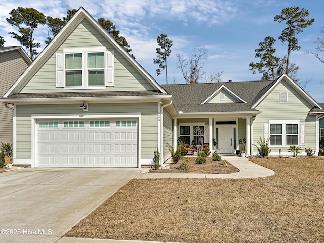 view of front of property featuring a garage, concrete driveway, a shingled roof, and a front lawn