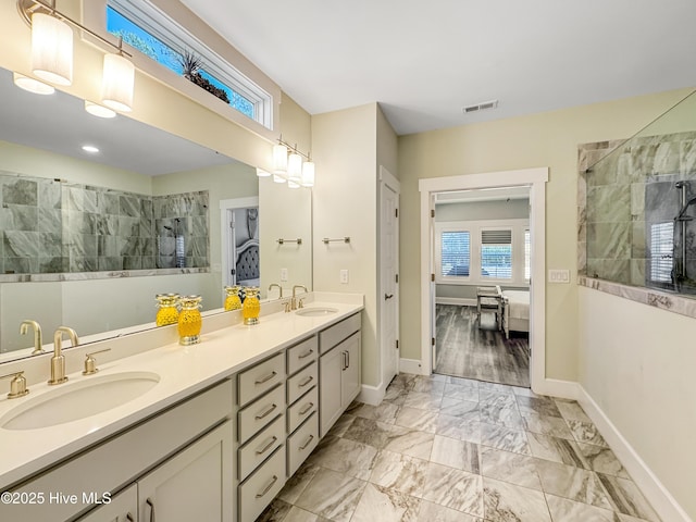 full bath featuring walk in shower, a sink, visible vents, marble finish floor, and ensuite bath