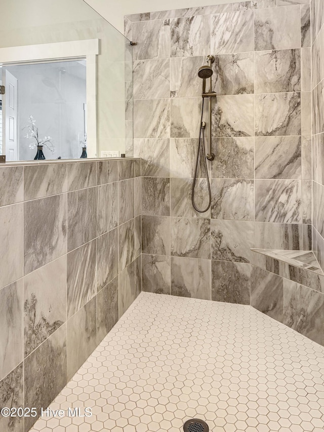 full bath featuring a tile shower