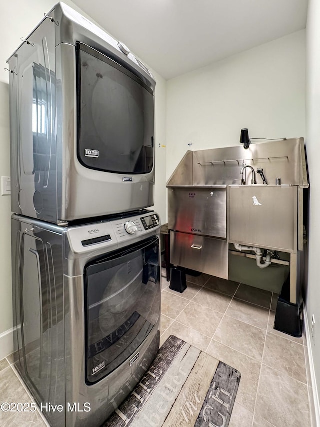 laundry area with laundry area and stacked washer / dryer