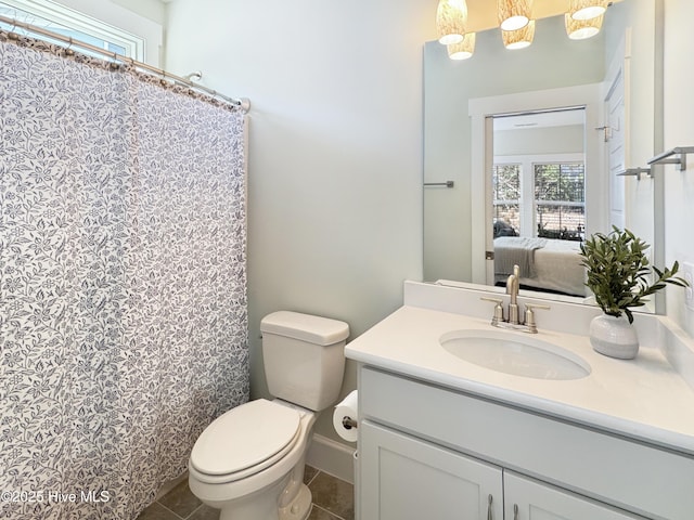 ensuite bathroom with tile patterned flooring, toilet, connected bathroom, a shower with shower curtain, and vanity