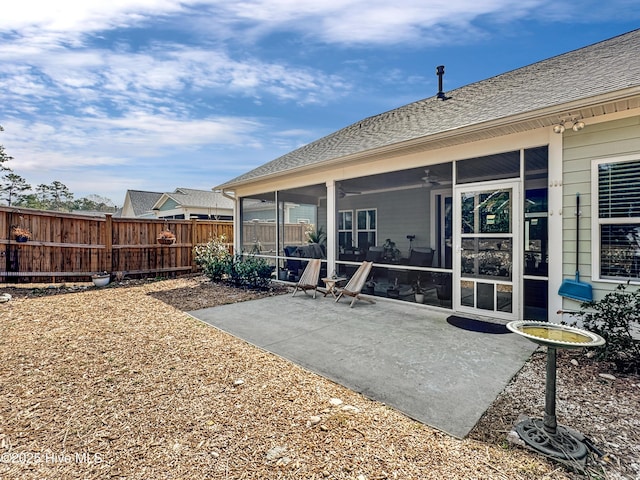 back of house featuring a patio, fence, a sunroom, a ceiling fan, and roof with shingles