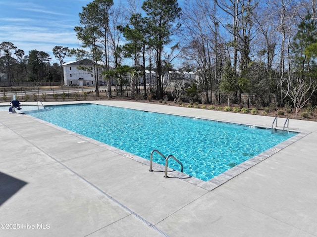 pool with fence and a patio