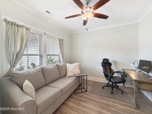 office area with baseboards, crown molding, visible vents, and wood finished floors