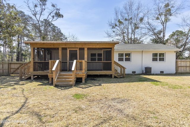 back of house with cooling unit, a yard, brick siding, a sunroom, and fence private yard