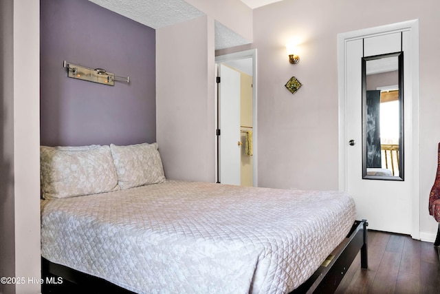 bedroom with dark wood finished floors