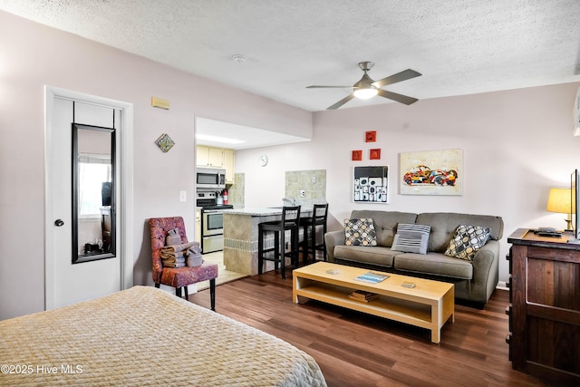 bedroom with a textured ceiling and dark wood-style flooring