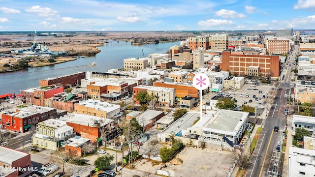 birds eye view of property with a water view and a city view