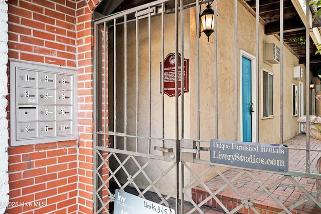 details featuring board and batten siding, brick siding, and mail area