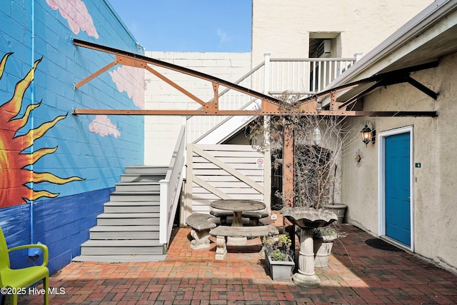 doorway to property with a patio area and stucco siding