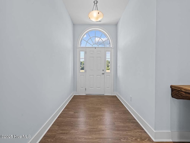 entryway with dark wood-style floors and baseboards