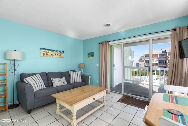 living area with light tile patterned floors and visible vents