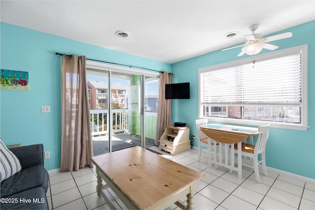 1618 Canal Dr Unit C-44, Carolina Beach, NC 28428 - living room with a ceiling fan, baseboards, light tile patterned flooring, and a textured ceiling