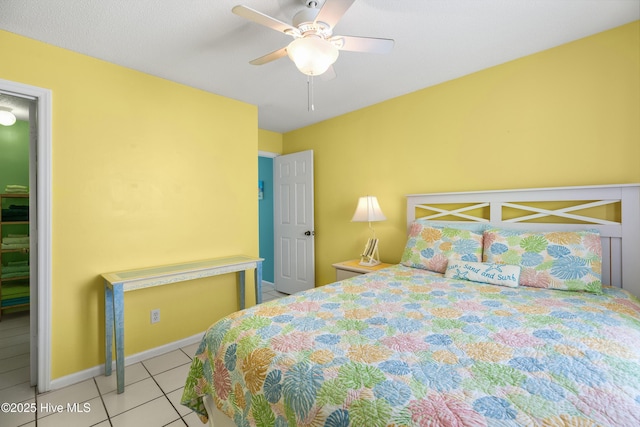 bedroom featuring ceiling fan, baseboards, and light tile patterned floors