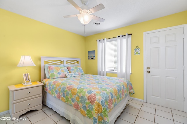 bedroom featuring light tile patterned floors, ceiling fan, visible vents, and baseboards