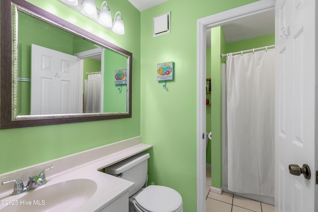 full bathroom with a textured ceiling, tile patterned flooring, toilet, vanity, and a shower with curtain