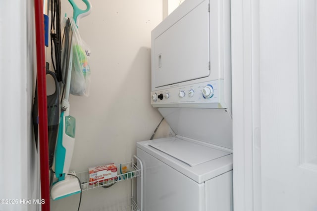 laundry area featuring stacked washer / dryer