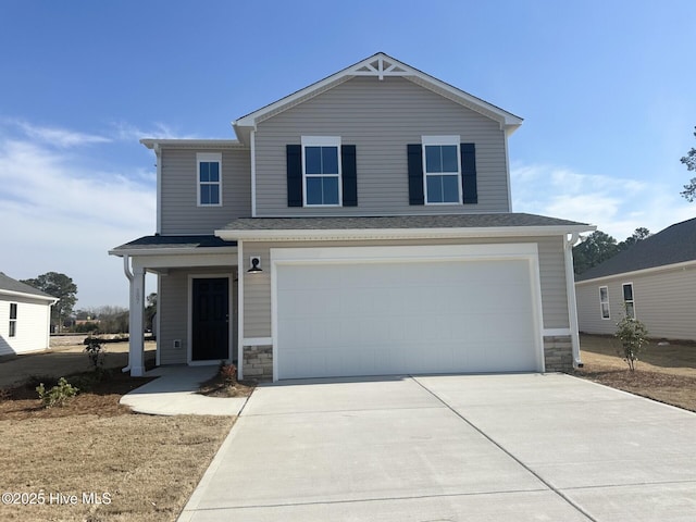 view of front of house featuring a garage, stone siding, and concrete driveway