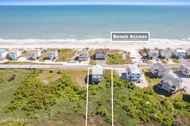 drone / aerial view with a water view and a beach view