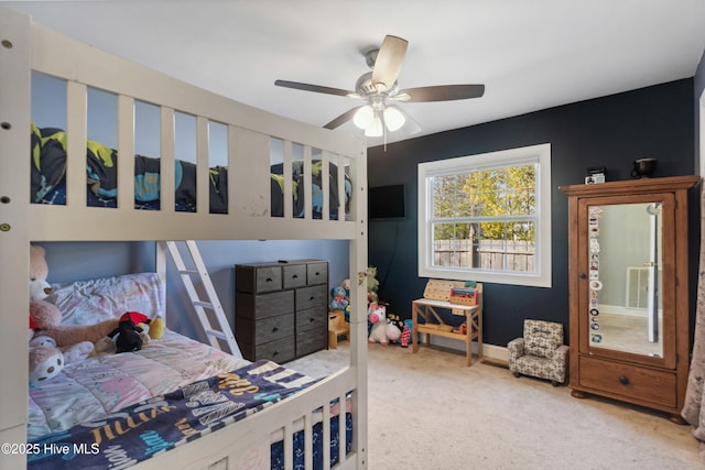 bedroom featuring carpet floors, baseboards, visible vents, and a ceiling fan