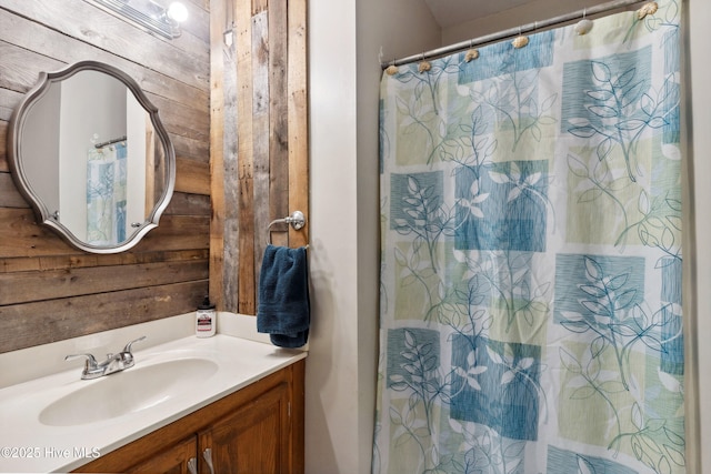 bathroom with wooden walls and vanity