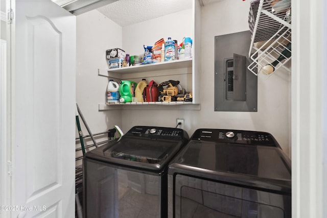 laundry area with a textured ceiling, laundry area, independent washer and dryer, and electric panel