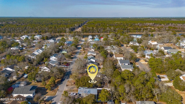 drone / aerial view featuring a residential view and a forest view