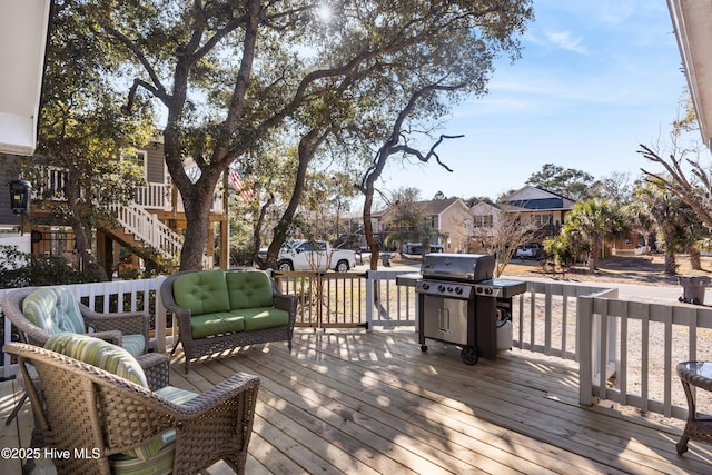 wooden deck with area for grilling and a residential view