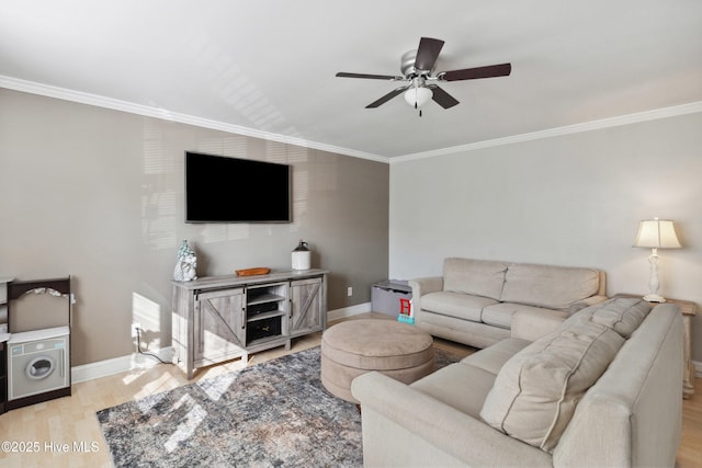 living room with baseboards, light wood-style floors, and crown molding