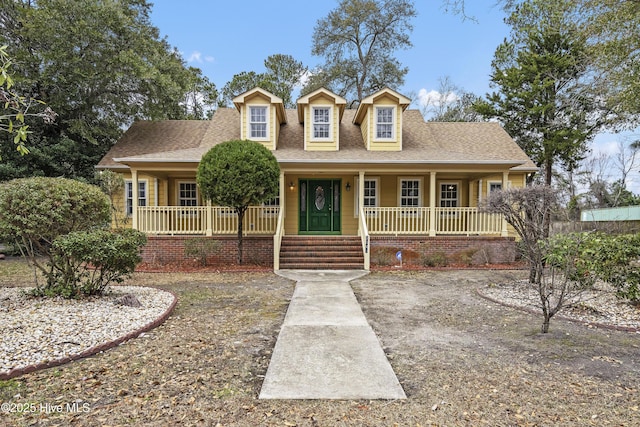 view of front of property with covered porch and a shingled roof