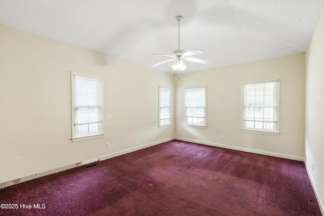 carpeted spare room with vaulted ceiling, a textured ceiling, a ceiling fan, and baseboards