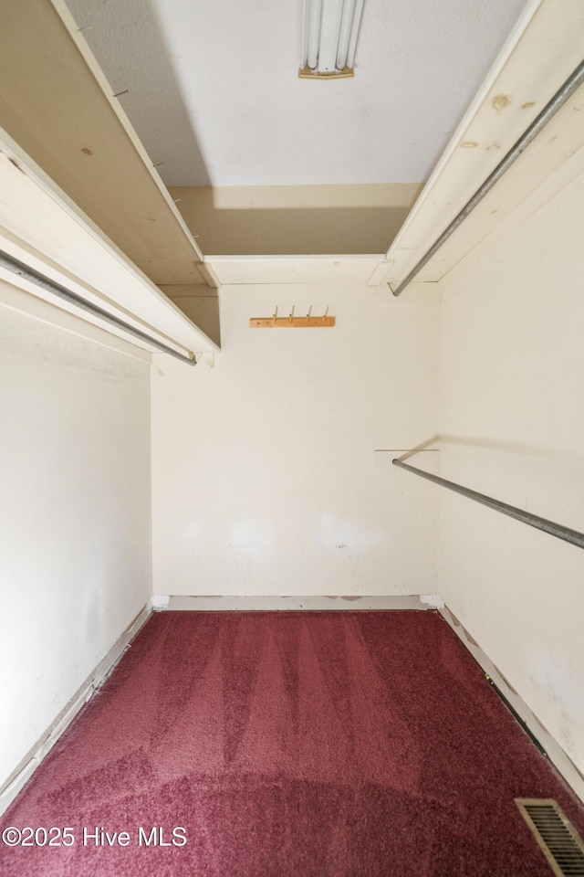 walk in closet with carpet flooring and visible vents