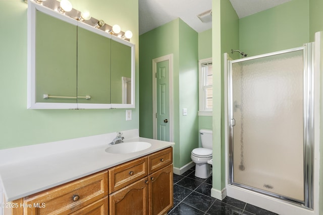 bathroom featuring toilet, vanity, baseboards, tile patterned floors, and a stall shower