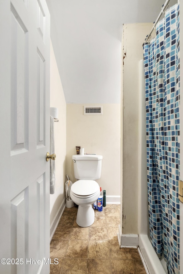 full bath featuring toilet, a stall shower, visible vents, and vaulted ceiling