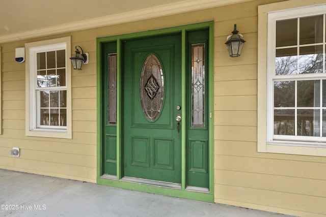 view of exterior entry with a porch