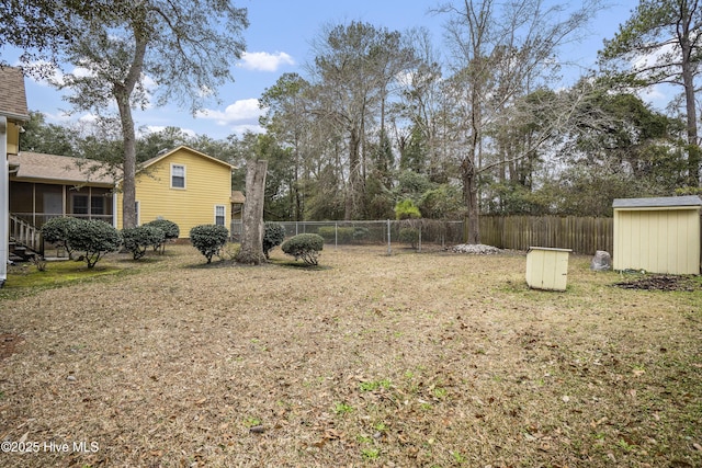 view of yard with a shed, fence, and an outdoor structure