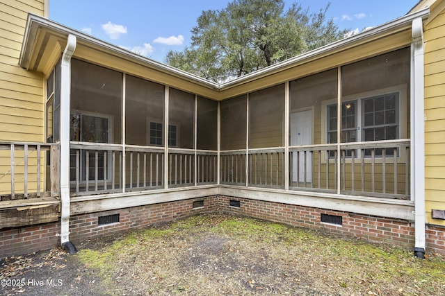 view of home's exterior featuring crawl space and a sunroom