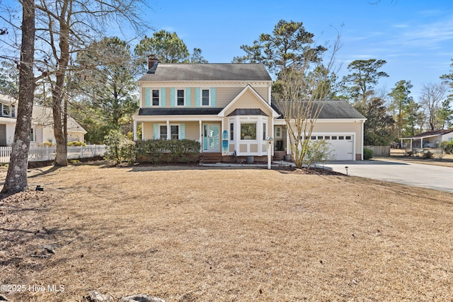 view of front of home featuring a garage, fence, concrete driveway, a front lawn, and a chimney